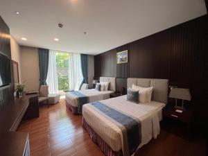 土龙木市米拉酒店的酒店客房设有两张床和电视。