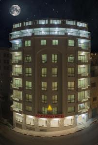 伯利恒圣家酒店的一座大型建筑,晚上有快乐的现实酒店