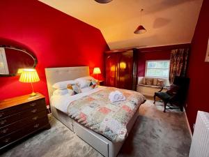 Nine Mile BurnWanton Wa's的卧室设有红色墙壁、一张床和一张书桌