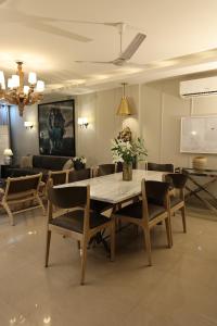新德里R6 Luxury Peacefull & Comfortable的客厅配有餐桌和椅子