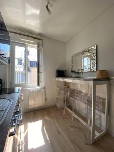 多维尔Studio avec terrasse à Deauville的一个带柜台和椅子的厨房