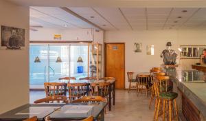 格塞尔镇拉斯格隆德里那斯的酒店的餐厅设有桌椅和窗户。
