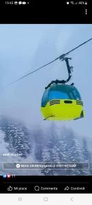 Statjunea BorsaCasa Roman的滑雪缆车上的黄蓝色火车