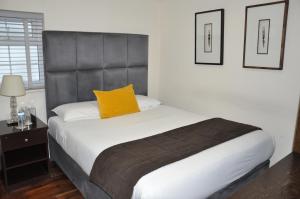 巴尔内特Nap Inn Savoro的一间卧室配有一张黄色枕头的床