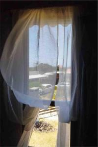 巴拉德瓦利扎斯Casa en Valizas a 250m del mar的窗户享有白色窗帘的景致