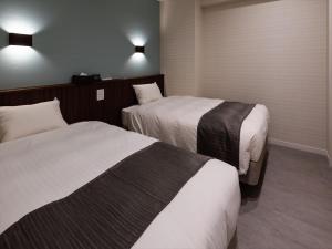 本部Sunset Resort Canphou的酒店客房,设有两张床和两盏灯