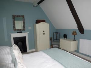 Wimborne Saint Giles家庭农场住宿加早餐旅馆的一间卧室配有一张床、梳妆台和镜子