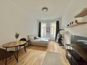 维也纳FeelHome-Margareten-2 Gäste-WiFi-SmartTV的客厅配有床和桌子