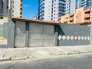 大普拉亚Seu Cantinho na Vila Tupi 3 Dormitórios的街道边有高楼建筑的建筑物