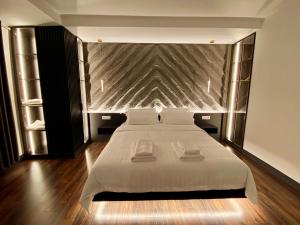 地拉那Tirana Central Rooms的卧室配有一张白色大床和两条毛巾