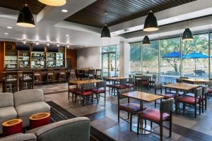 梅萨凤凰城梅萨门户机场喜来登福朋酒店的一间带桌椅的餐厅和一间酒吧