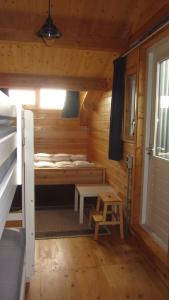 劳雷尔苏格Boothuis Lauwersoog的小屋设有床和凳子