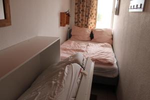 斯洪保因霍泰Ferienwohnung L412 für 2-4 Personen an der Ostsee的小房间设有两张床和窗户