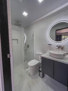 卡里略Fortu House的一间带水槽、卫生间和镜子的浴室