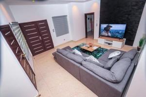 科托努RESIDENCE MH SERVICES Cotonou的带沙发和平面电视的客厅