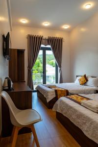 Tánh LinhHotel Mỹ Vy的酒店客房带两张床、椅子和窗户