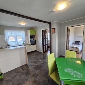 布伦迪欧斯克宜岩宾馆的厨房以及带绿色桌椅的用餐室。