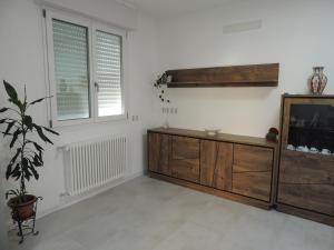 多莫多索拉Casa Cortina的客厅设有木制梳妆台和2扇窗户