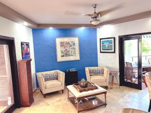 里奥格兰德Come, Enjoy & Relax at Rio Mar Cluster II, Rio Grande, PR的客厅配有两把椅子和蓝色的墙壁