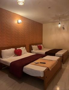 科代卡纳尔Cloudsmisty kodai的一间卧室配有两张带红色枕头的床。
