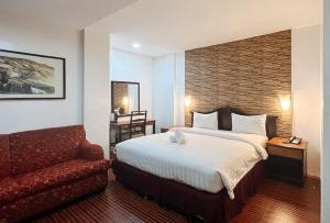 安吉利斯RedDoorz at Diamond Spring Hotel Angeles City的配有一张床和一把椅子的酒店客房