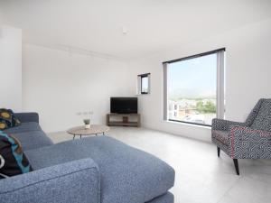 阿维莫尔Caledonia View的客厅配有2张蓝色沙发和电视