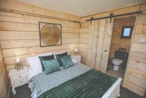 HiltonEdgmond Lodges - Scropton的一间卧室设有一张床和一个卫生间。