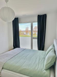 ErmatingenHaus am Bodensee mit Sicht - Stilvoller Luxus的一间卧室设有一张床和一个大窗户