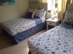 CosónVilla Mares en Playa Bonita ,coson Las Terrenas的一间卧室配有两张带蓝白色床单的床