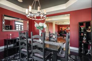 斯蒂迪奥城Hills of Studio City, your serene home away from Home的一间拥有红色墙壁和桌椅的用餐室