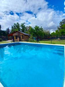 Las CompuertasCasa Lutan ,Mendoza, 6 personas ,Montaña y bodegas的一座大蓝色游泳池,位于房子前
