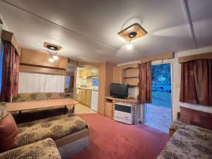 赫尔Your Caravan Hel的一间带两张床和电视的客厅