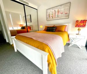 黄金海岸Ollies Place的一间卧室配有一张大床和镜子