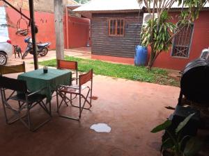 伊瓜苏港La casa de Tilili的一个带桌椅的庭院和一座房子