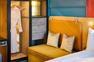 利物浦The Halyard Liverpool, Vignette Collection, an IHG Hotel的一间卧室配有黄色椅子和衣柜