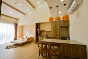 富国Aurora Phu Quoc Hotel & Cafe - Summer Deal - Free 1-2 Cable Car Tickets & Aquatopia Water Park的一间厨房,里面配有桌椅