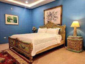 杜马格特Residencia Orlina的一间卧室配有一张大床和一个带灯的床头柜