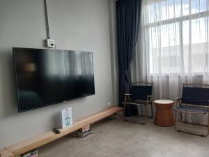 甲米镇Into the town krabi的客厅配有壁挂式大屏幕平面电视