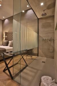 的里雅斯特Forvm Experience的卧室内的玻璃淋浴间,配有床