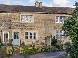 埃文河畔布拉德福1 bed property in Bradford-On-Avon 82251的前面有两把椅子的砖房