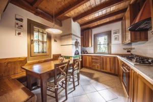 摩德纳迪-坎皮格里奥Holiday home in Campo Carlo Magno 24162的厨房配有木桌和木橱柜。