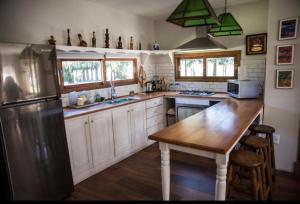 杜拉斯诺Chacra Los Arándanos的厨房配有不锈钢冰箱和木桌