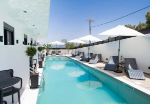 雷夫卡达镇Solvio Boutique Hotel & Spa的一个带躺椅和遮阳伞的游泳池