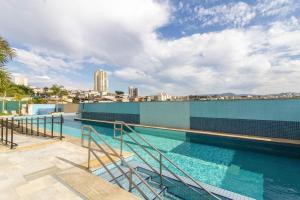 瓜鲁柳斯Apartamento 408 em condomínio de alto padrão的建筑物屋顶上的游泳池