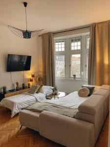萨尔布吕肯Exklusives Apartment im Herzen Saarbrückens的客厅设有两张床,配有沙发