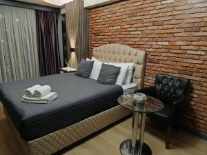 伊斯坦布尔Nomad Hub Istanbul Residence的一间卧室设有一张床和砖墙