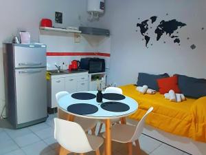 门多萨APART CENTRO RIOJA, Zona Residencial, Parking privado gratis a 100 mts的厨房配有桌子和黄色的床