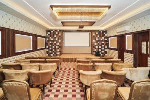 科钦Burooj Hotel的一个带椅子和投影屏幕的会议室