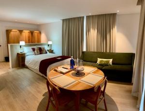 奇皮奥纳Apartamentos Turísticos La Plaza的酒店客房配有床、桌子和沙发。