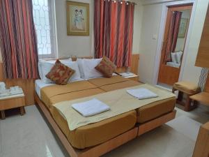孟买Empire Hotel - Grant Road的一间卧室配有一张大床和两个枕头
